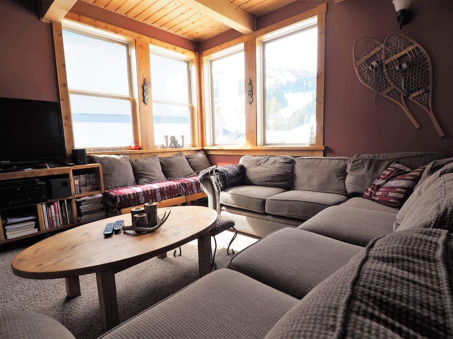 The large sectional couch can be hard to leave with the amazing views and warm wood fire place
