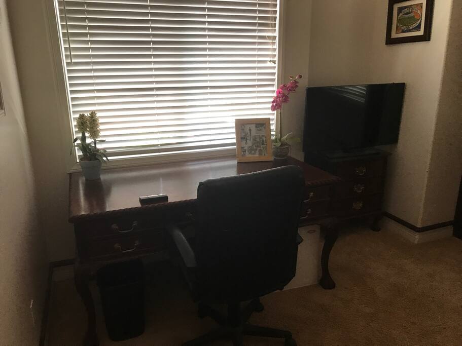 Desk with a small mini fridge under it.