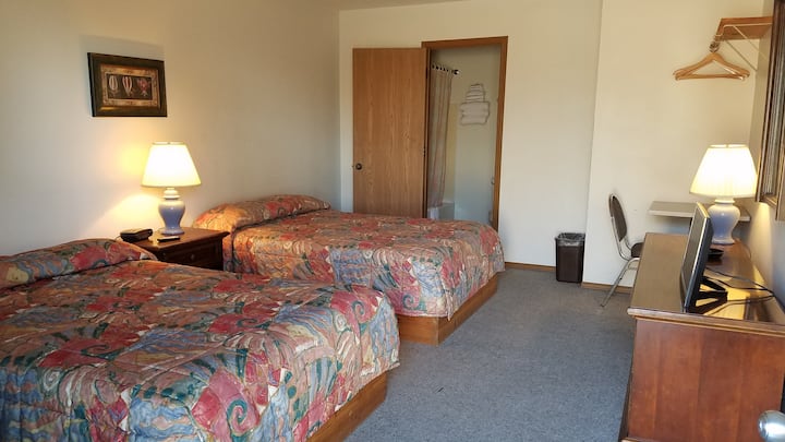 Room 1 with two full-size beds, private entrance, bath, and TV