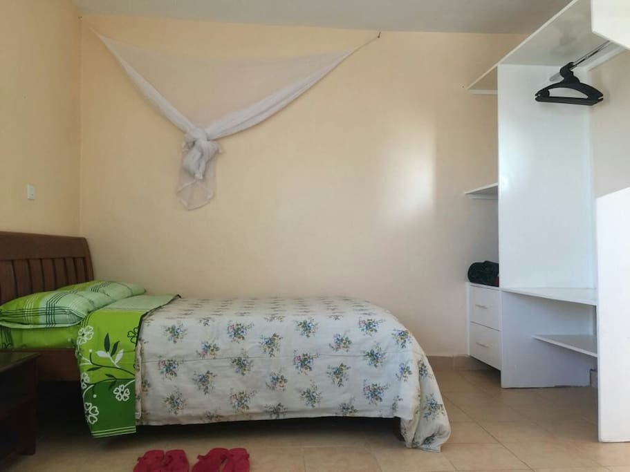 Double bed with a mosquito net, spacious wardrobe space