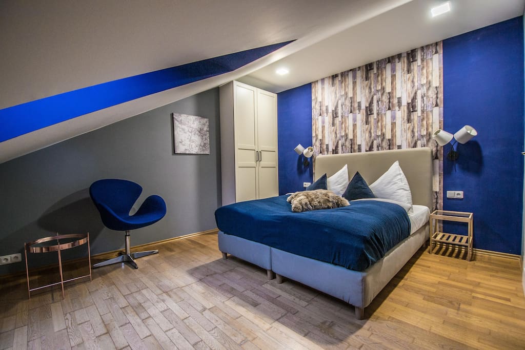 2nd bedroom with a queen bed, design chair and a huge wardrobe :)