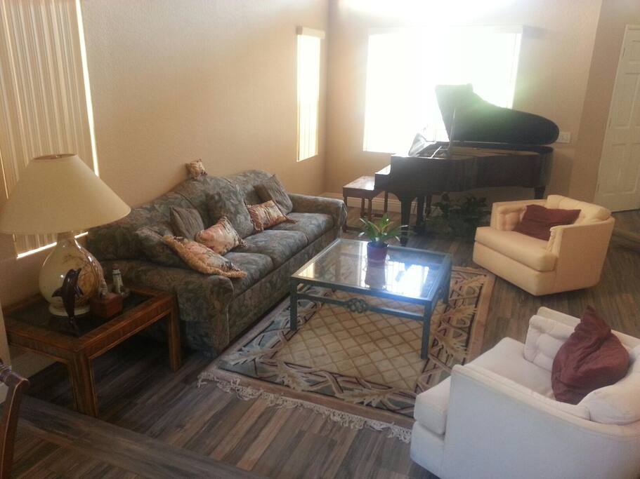Living room with baby grand piano built in the 1940s