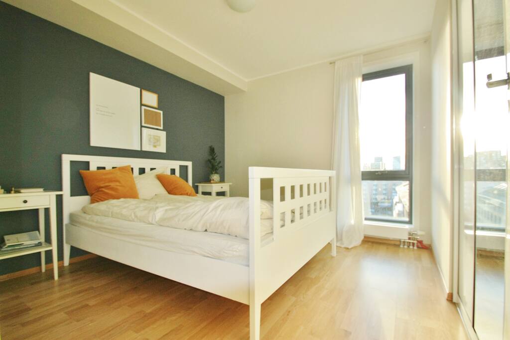 Bedroom with queen size bed and view of skyline