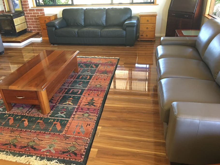 Lounge area with 3 x leather couches and fireplace