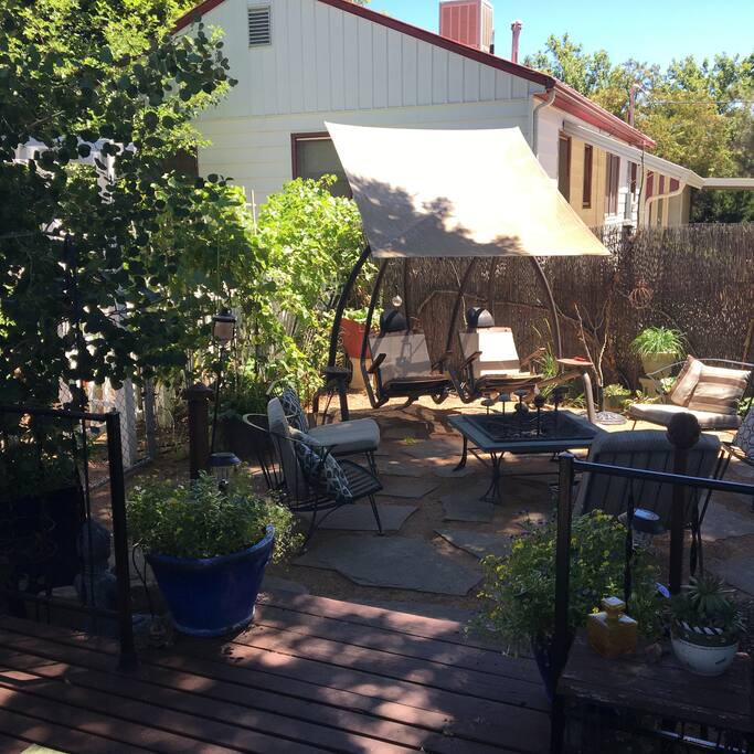 Many guests' favorite: our two person swing -- individually swinging, with foot rests, adjustable umbrella, and reclining seats -- nestled among the grape vines and garden area.