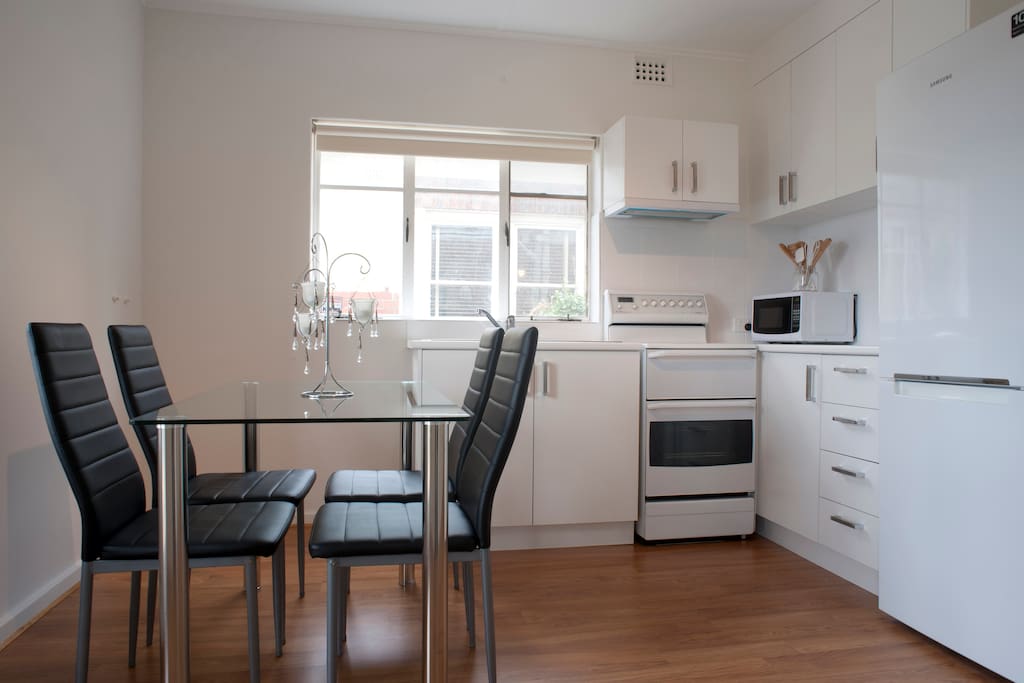 Fully functional spacious kitchen with electric cooktop, oven, fridge/freezer, microwave, toaster, coffee plunger, kettle, kitchen utensils, cutlery and dining space