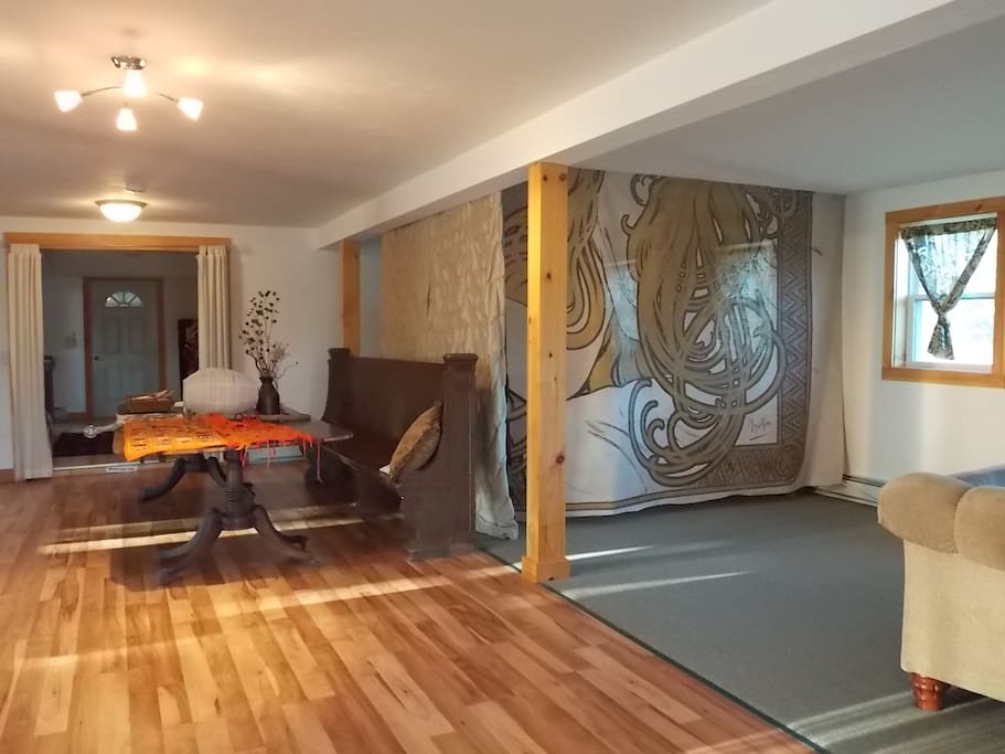 Our oversized studio 26' x 26' hosts a curtained sleeping area with a queen bed (shown) The other 2 twin beds are in the open studio space.