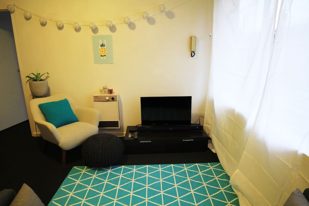 Cosy living room - TV with DVD player, Apple TV and wifi - local artworks and designer reading armchair