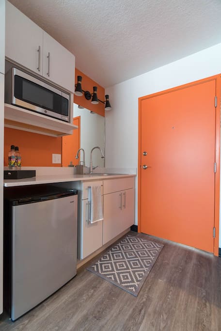 Kitchenette area with under-mount refrigerator and microwave included.