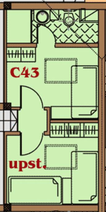 This is the first floor. It's in the eves of the building. Roof lights service this floor. There is a queen bed in the en-suite room, and there is a twin bedroom adjacent.