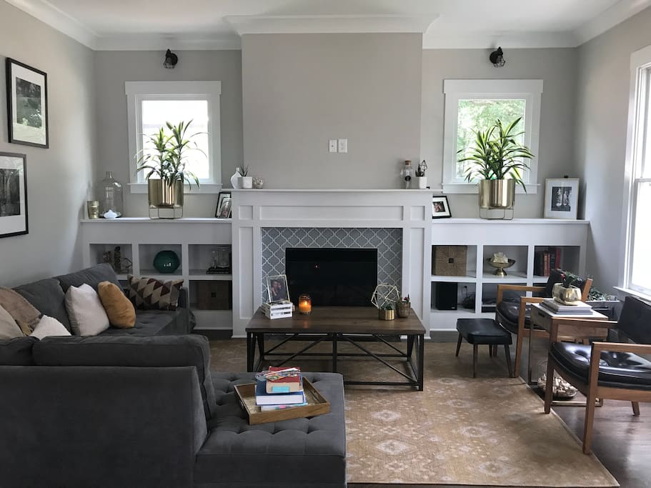 Living room with fireplace and lots of natural light.