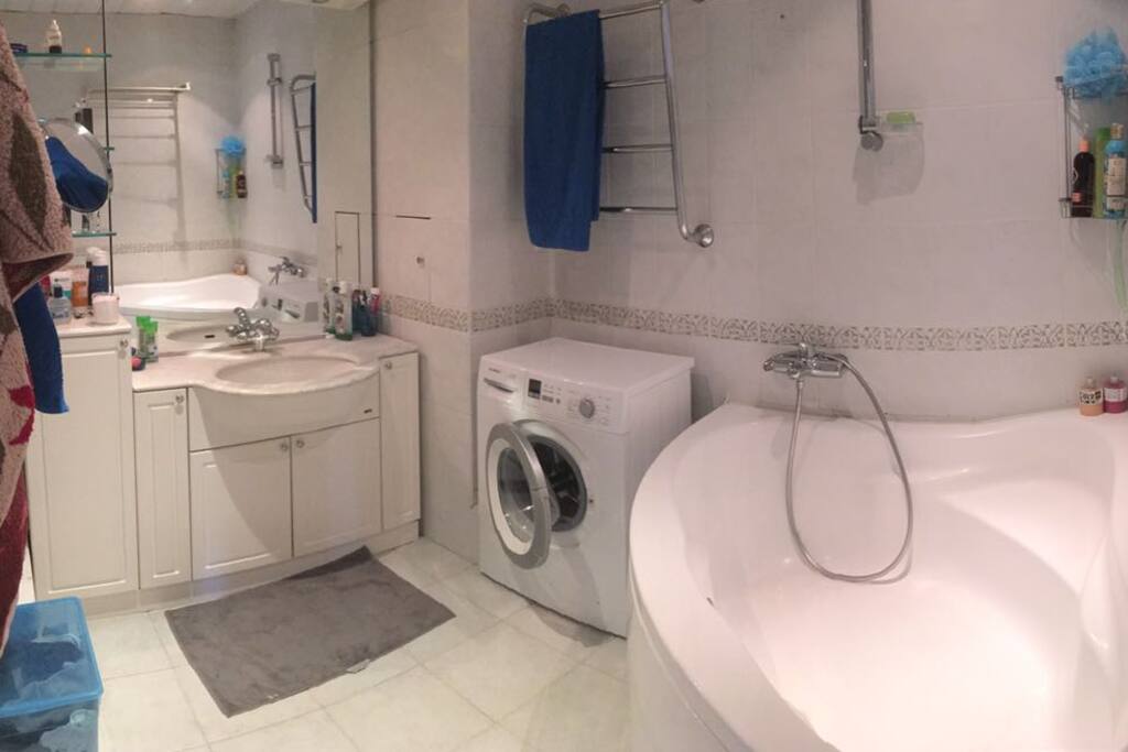 Nice white-tile bathroom with an ENORMOUS tub where you can soak out all your fatigue