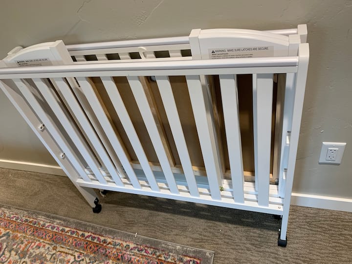 foldable crib is stored under the bed. Takes a little technique to wiggle it between the bed supports 