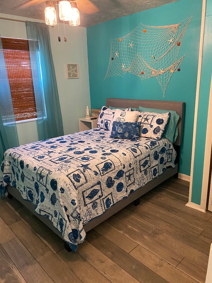 Bedroom with full size bed and smart TV