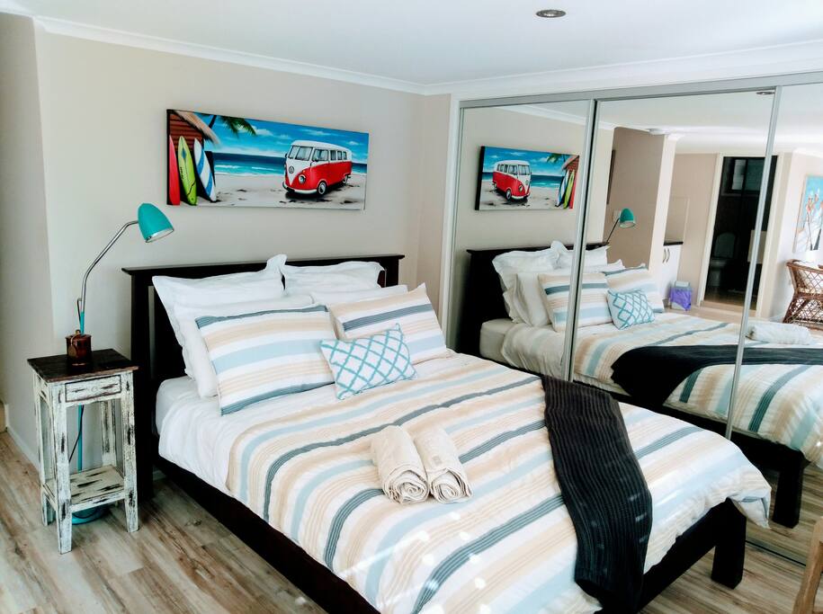 The queen bed space - Luxury bed linen. Cool coastal themes to match overall living space.