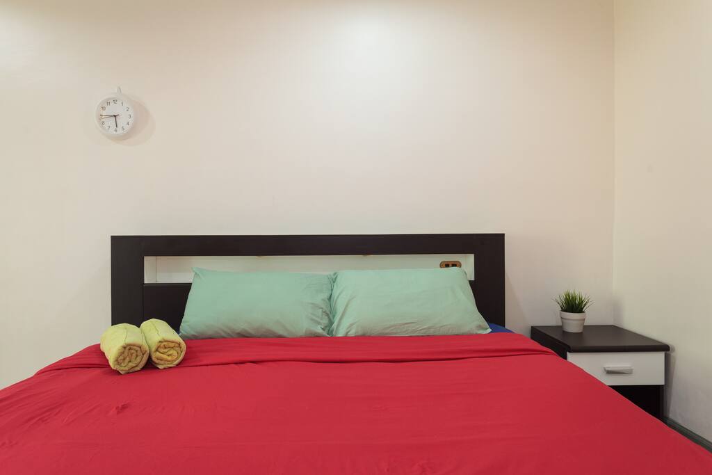 Comfy king size bed covered with soft mattress.