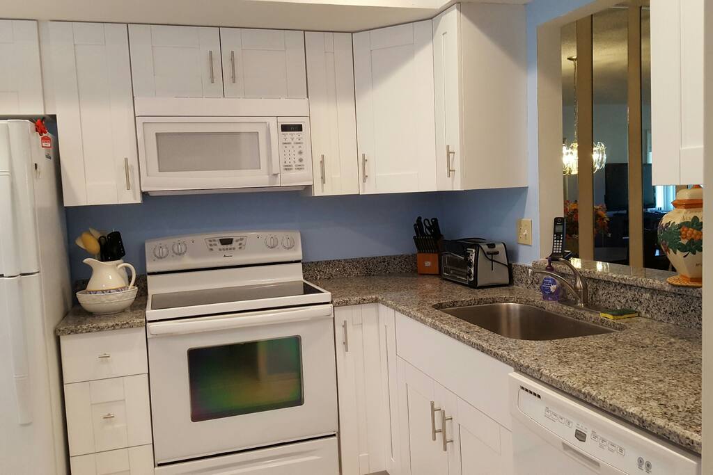 Newly renovated kitchen with granite countertops and new cabinets