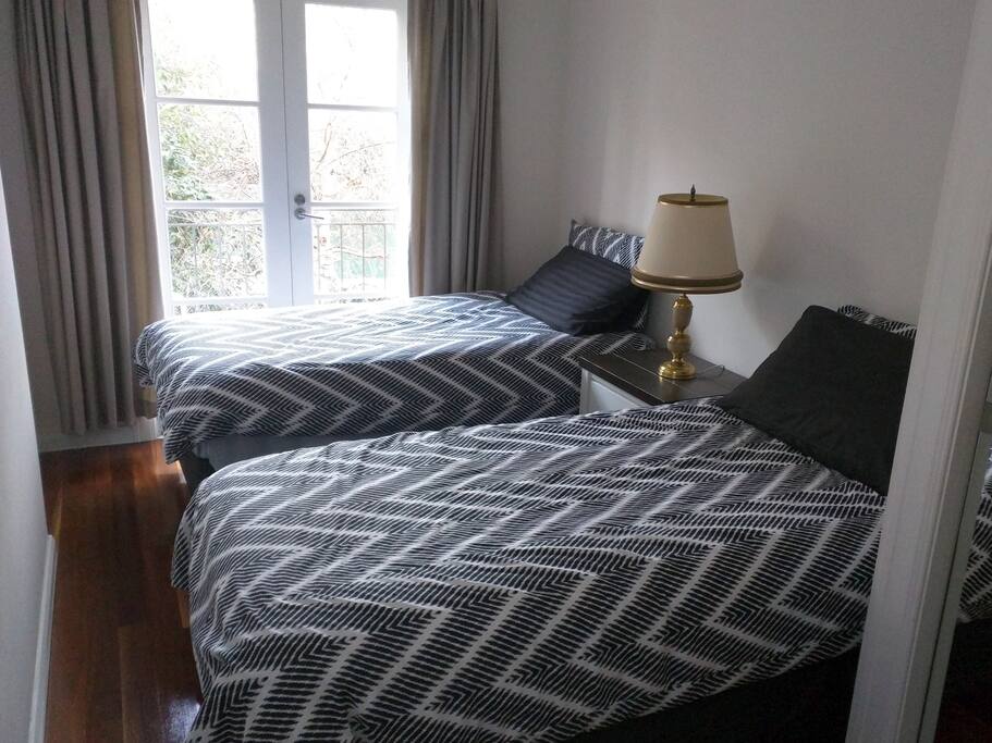 Second bedroom. 2 single beds leading out to balcony.