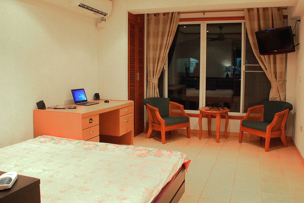 King-size bed, chairs and table, working desk, AC, TV
