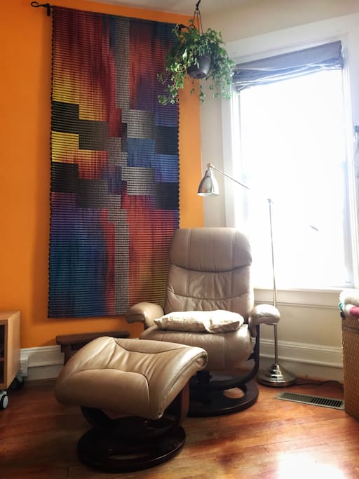 Cozy up with a book next to a handwoven Incan art piece