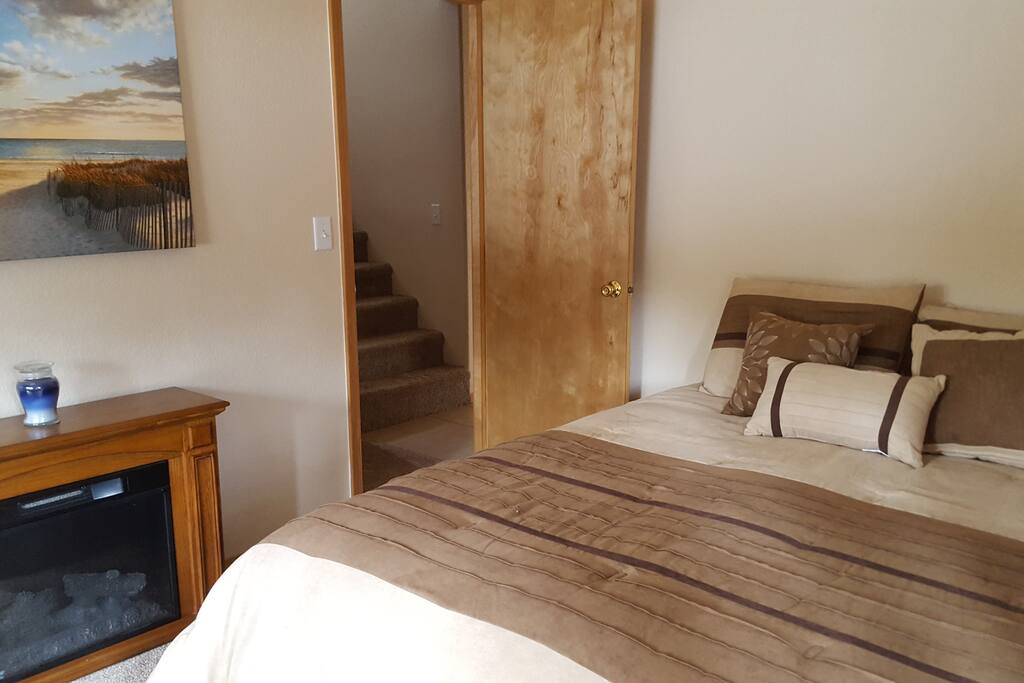 Guest bedroom with electric fireplace