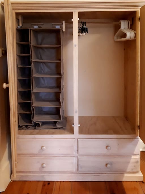 Full sized wardrobe with four draws and plenty of coat hangers.