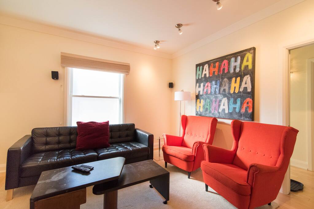 Living room with comfortable seating and 43 inch plasma with cable.