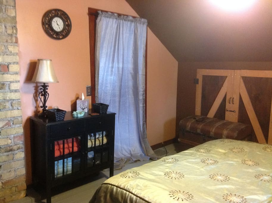 Linens, towels and curtains are stored in the side board and antique trunk.