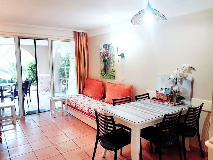 Vue du salon et de sa terrasse avec ancienne banquette gigogne remplacée par le canapé clic clac convertible lit double taupe