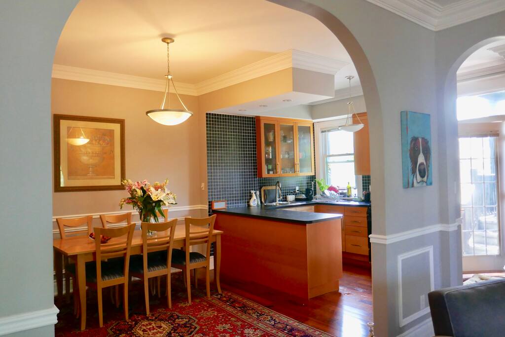 open plan dining for six with fully equipped kitchen and door leading out to private patio