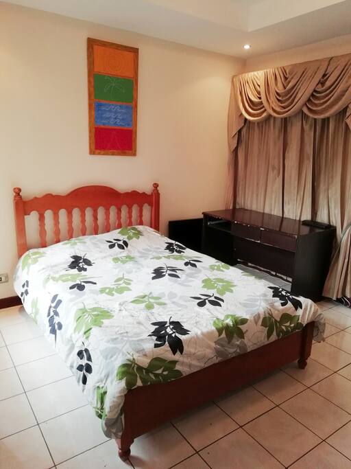 Full size bed with desk and closet.