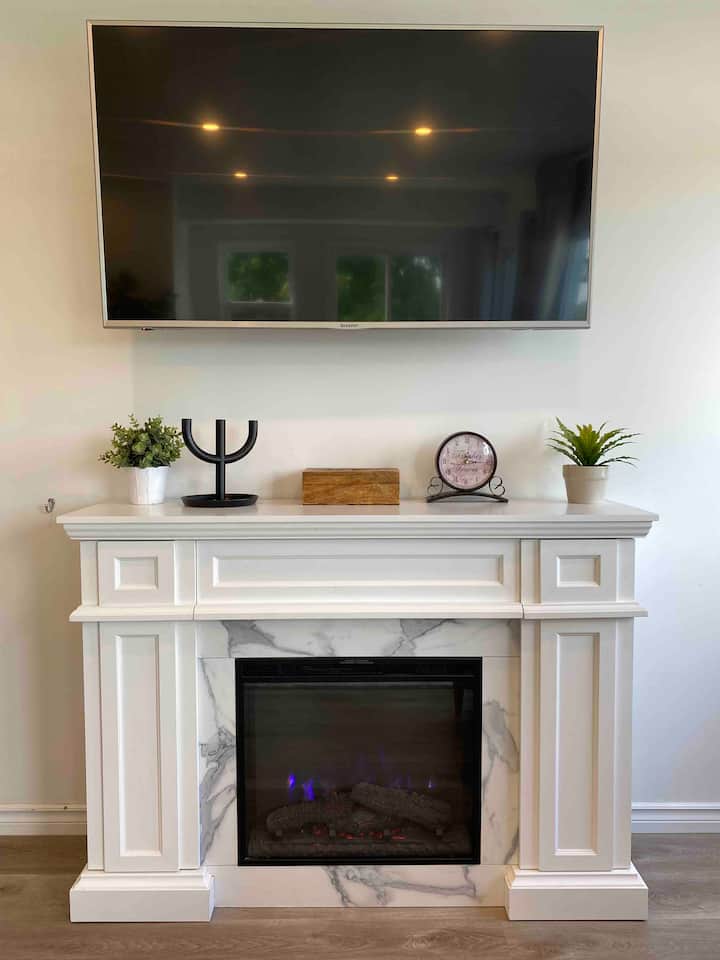 Cozy electric fireplace with 55” TV with Roku attached. 