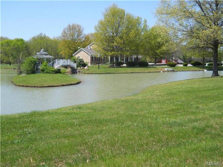 Fully stocked lake with bridge over lake to island with gazebo