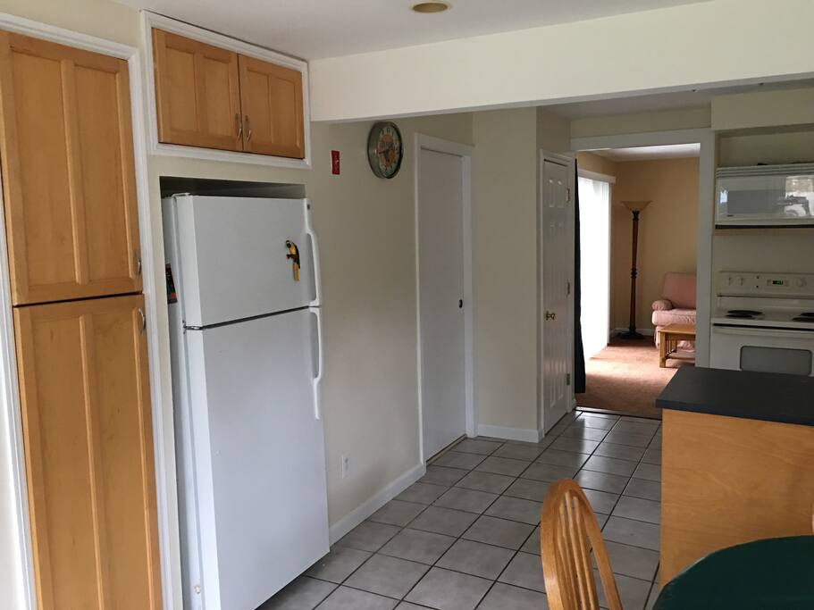 View of kitchen going into the living room from the entry of the duplex apartment. Entry is in the dining area.