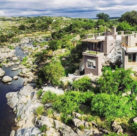 Cave house with a mountain river