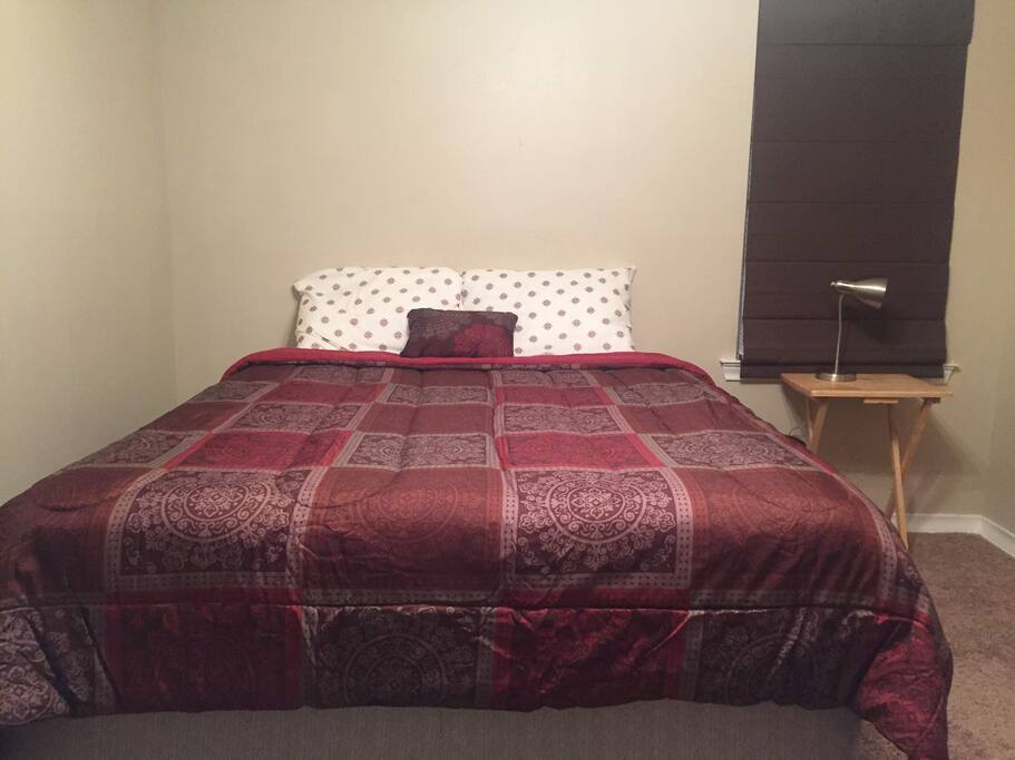 Comfy Queen Sized Bed with blackout night shades for a restful sleep!
