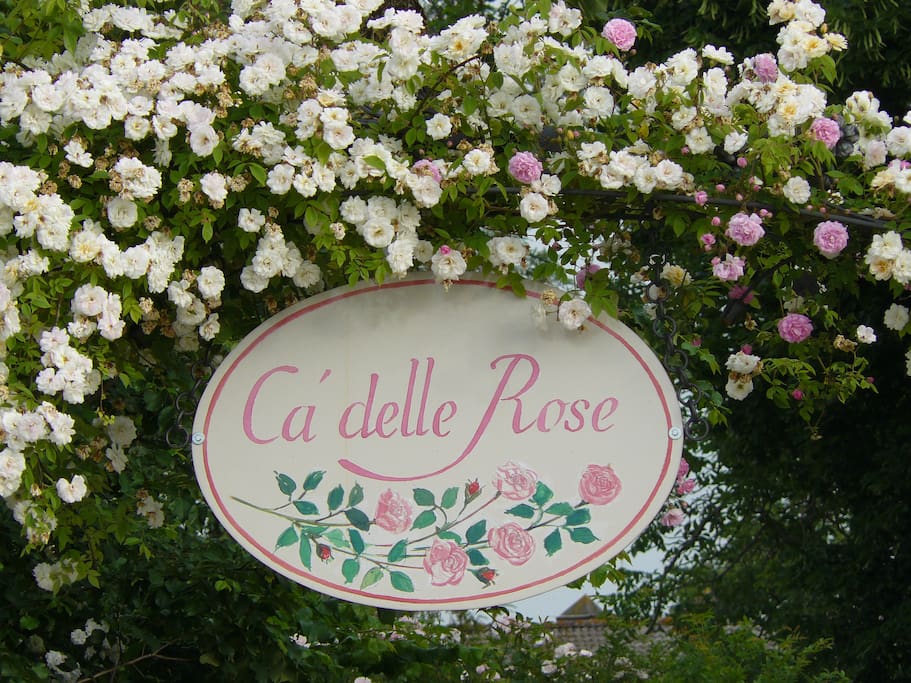 Ca' delle Rose Eco Luxury B&B signboard on the entrance gate