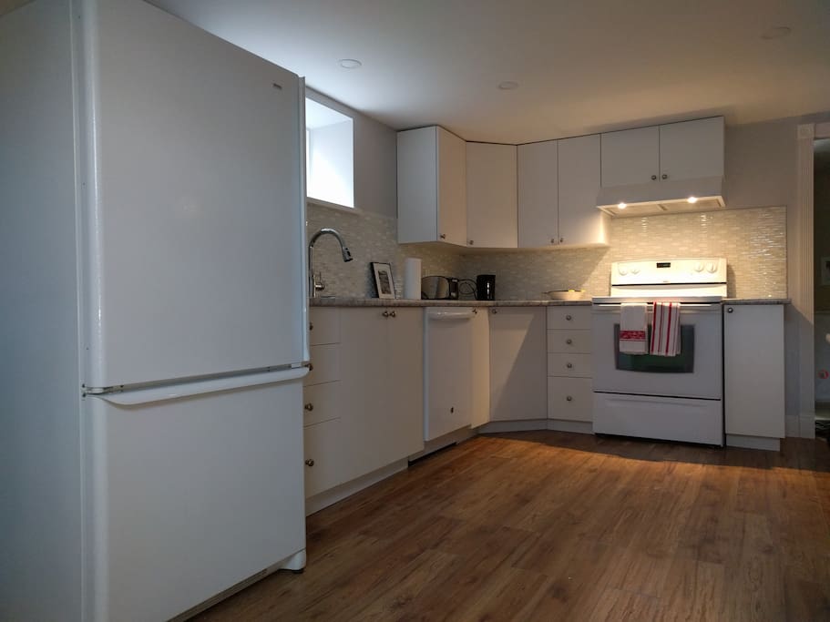 Bright and spacious kitchen, with induction cooktop and microwave.
