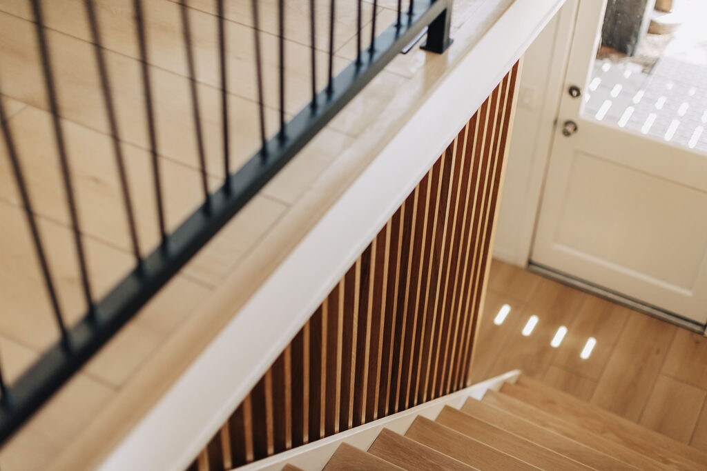 Descend toward the lower sleeping area, and be greeted by our custom white-oak slated stairway...the epitome of Mid-Century Modern Design!