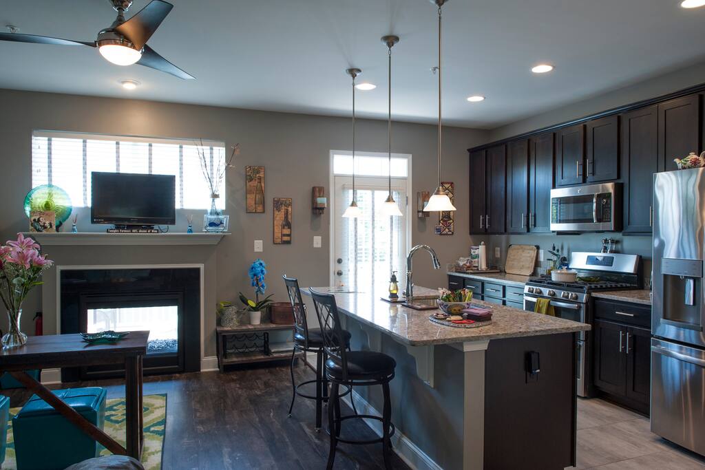 Main level (2nd floor) showing family room, kitchen, and indoor/outdoor fireplace.