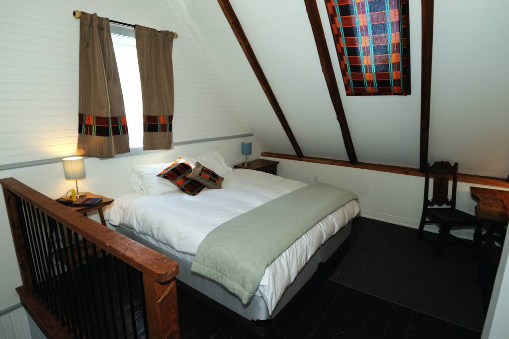 The king bed in the loft-like space.