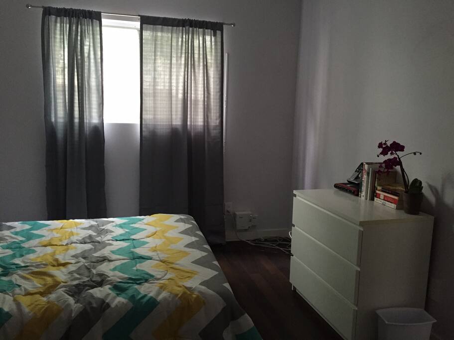Simply decorated bedroom with private closet and dresser.