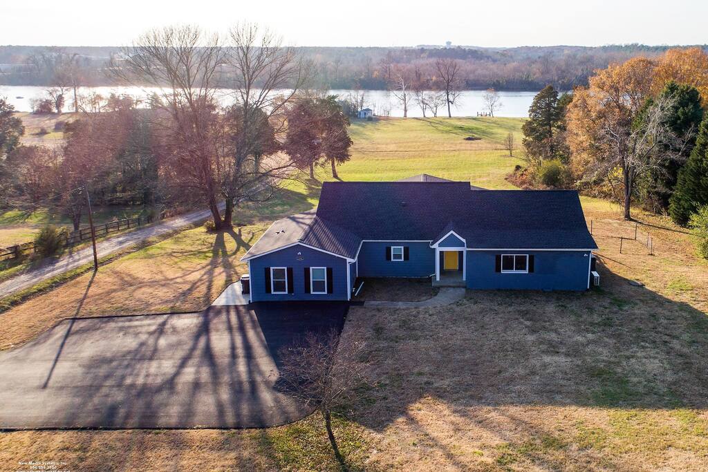 Guest parking in the driveway and private entry on the left of the house