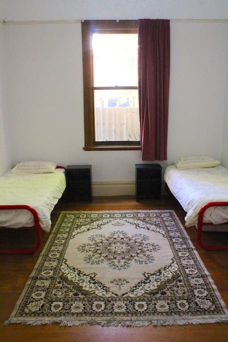 This is a simple but pleasant room with two single beds and a desk and chair for your use.