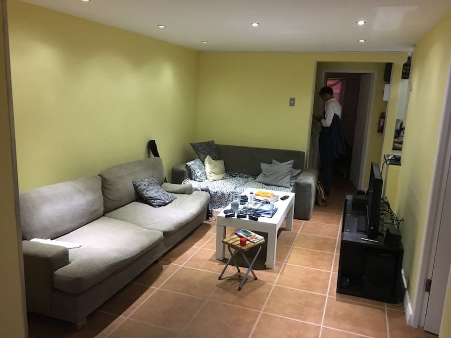 Living Room with TV, surround sound and Xbox for media and gaming.