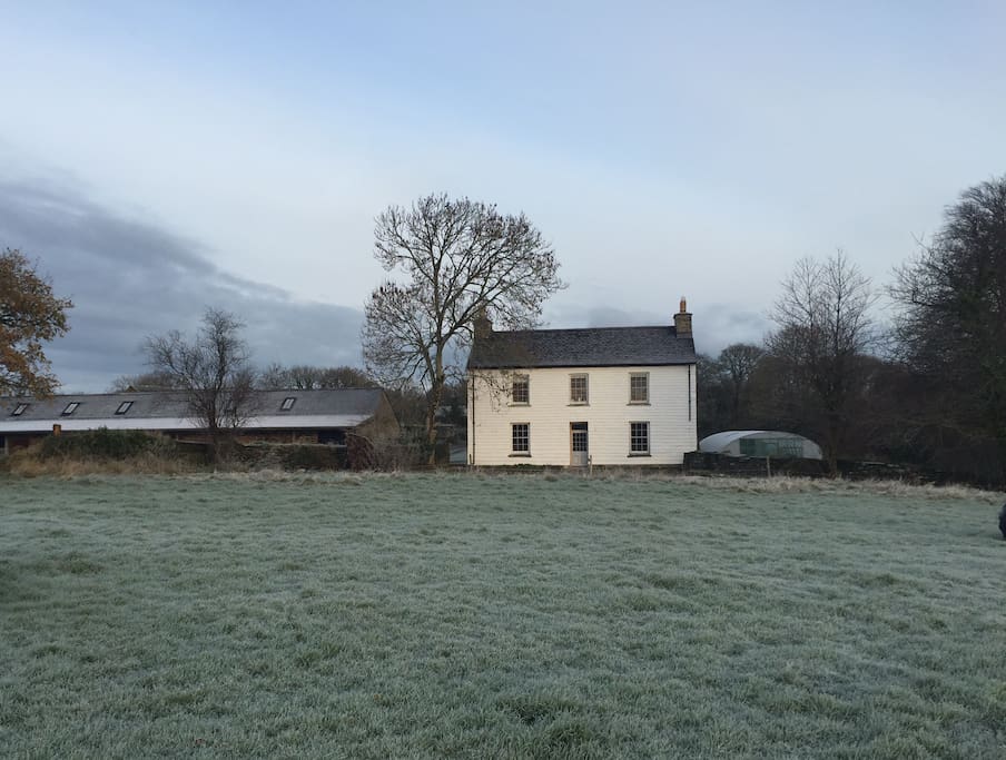 The restored Georgian Farmhouse overlooking the Welsh hills & countryside.