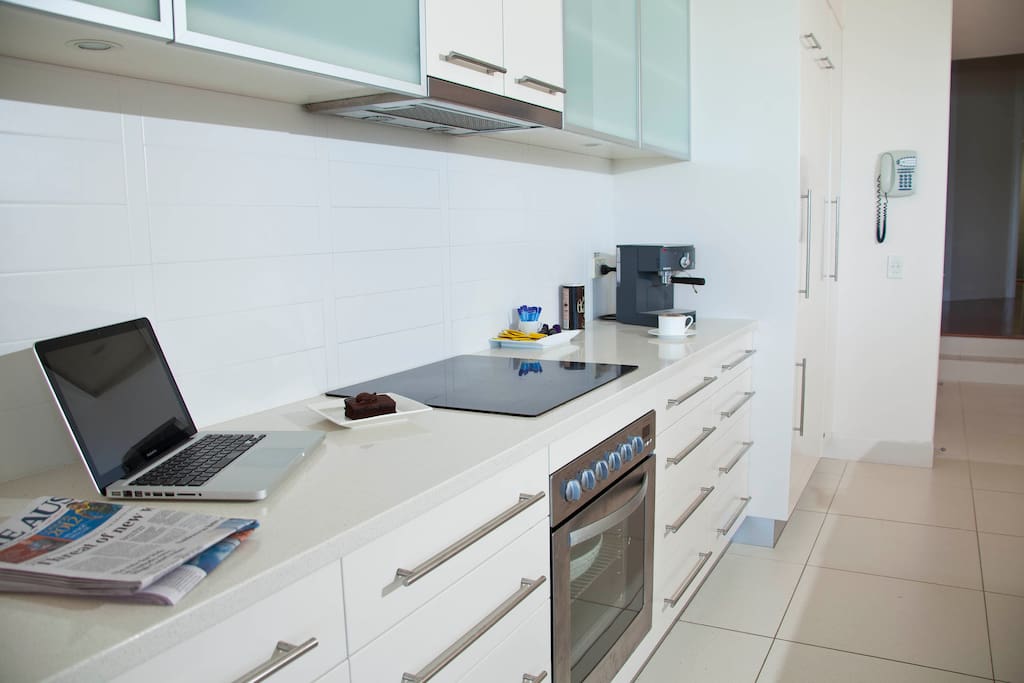The kitchen is sleek, spacious, and well equipped.