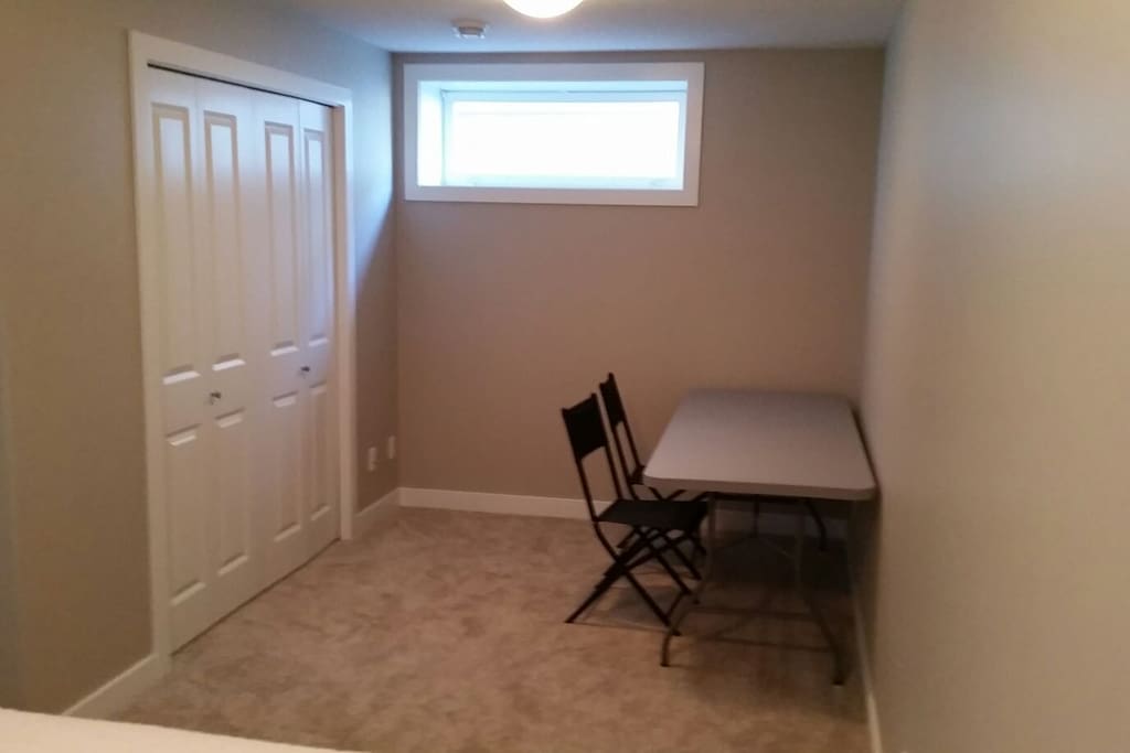 Other half of the room with table and closet.
