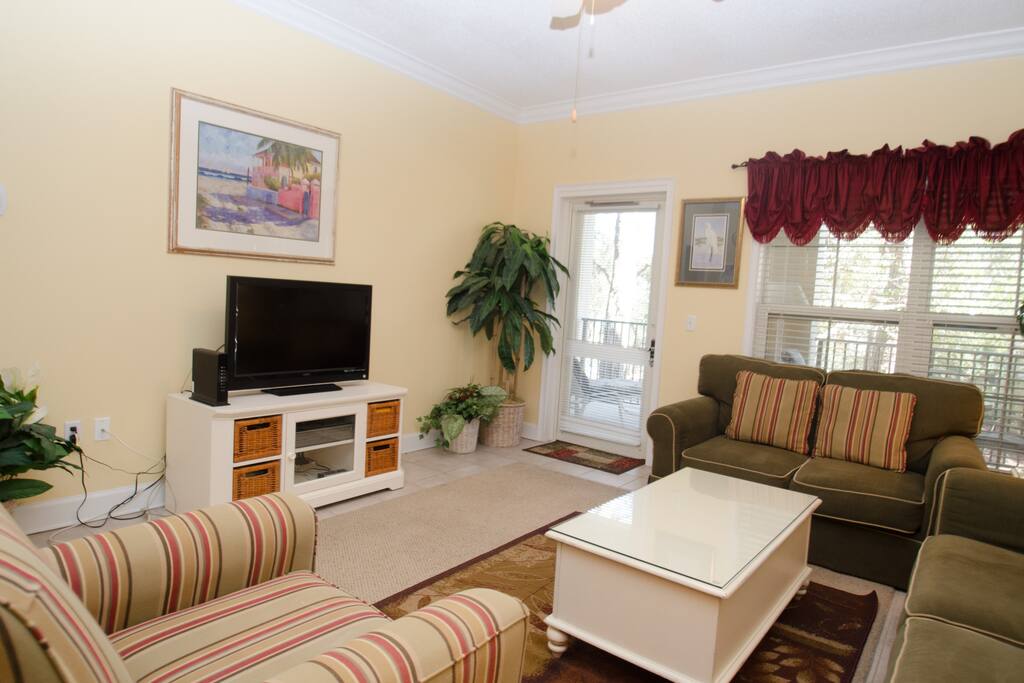 There is a flat screen TV and plenty of comfortable seating.