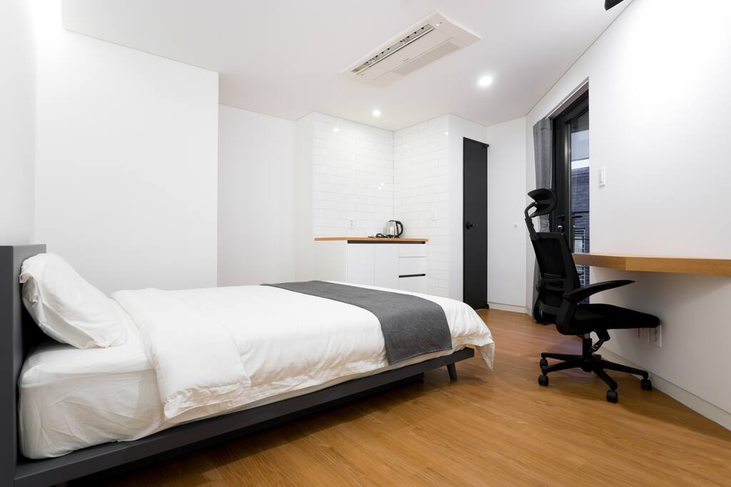 Notice the floating desk and work chair. The queen bed has a latex topper and high quality latex pillows for extra comfort